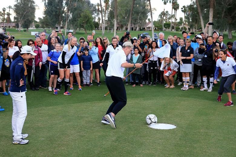 Paula Creamer (centre, background) watching anxiously during the ANA Footgolf Faceoff, as her "foot putt" goes into the hole at the Mission Hills Country Club on Tuesday in a preview to the ANA Inspiration. 