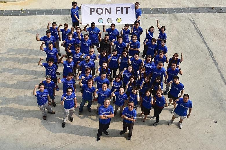 Pon Asia president Sim Bee Lim (front, left) and vice-president Quek Boon Sing (front, right) with employees of their company who are participating in the ST Run on May 22. With more than 120 sign-ups, the company is currently the largest contingent 