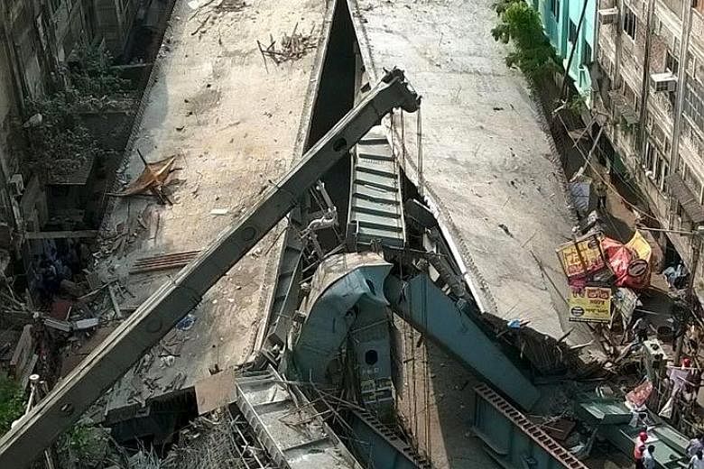 Rescuers at the site of the accident in Kolkata yesterday. Up to 150 people are believed to be buried under the rubble, and the death toll is expected to rise. Indian media have labelled the disaster "man-made".