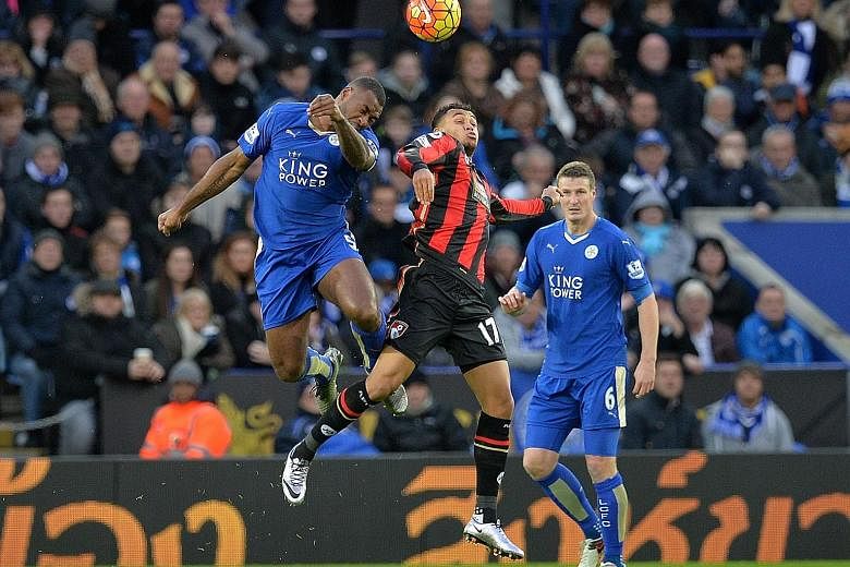 Leicester's Wes Morgan (left) and Robert Huth (right) in action against Bournemouth's Joshua King in a Premier League match in January. Alex Ferguson believes that the duo's defensive partnership has been vital in Leicester's success this season.