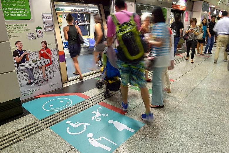 A priority queue sticker at Outram Park MRT station, one of six stations in a pilot for the programme to gather feedback from commuters before a tender is called.