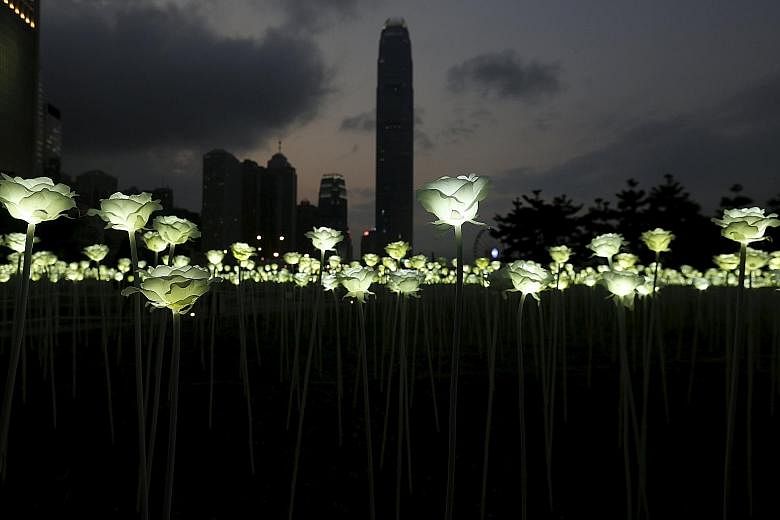 Illuminated rose-shaped LED lights at Admiralty in Hong Kong. S&P's downgraded the outlook for the city to negative even as it cut the credit rating for China, following a similar move by Moody's early last month.