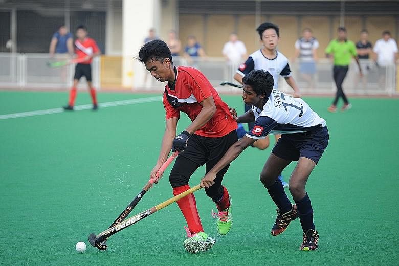 A St Andrew's player (right) challenging his Seng Kang opponent. St Andrew's won 2-0 to make up for last year's disappointment.