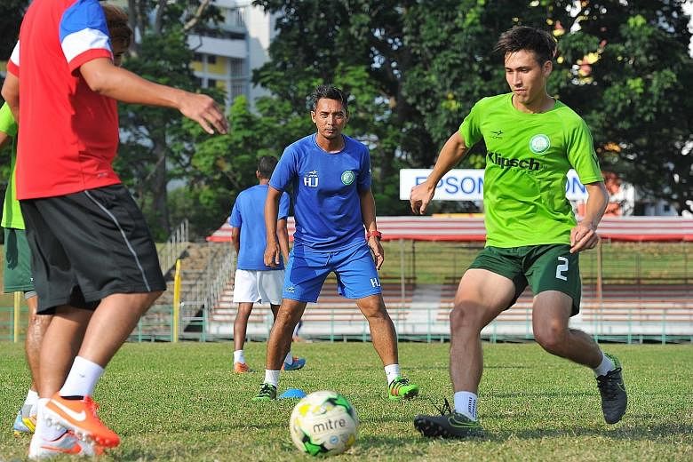 Geylang International head coach Hasrin Jailani (centre) and midfielder Anders Eric Aplin during training at Bedok Stadium on Wednesday, in preparation for the game against Warriors FC today.