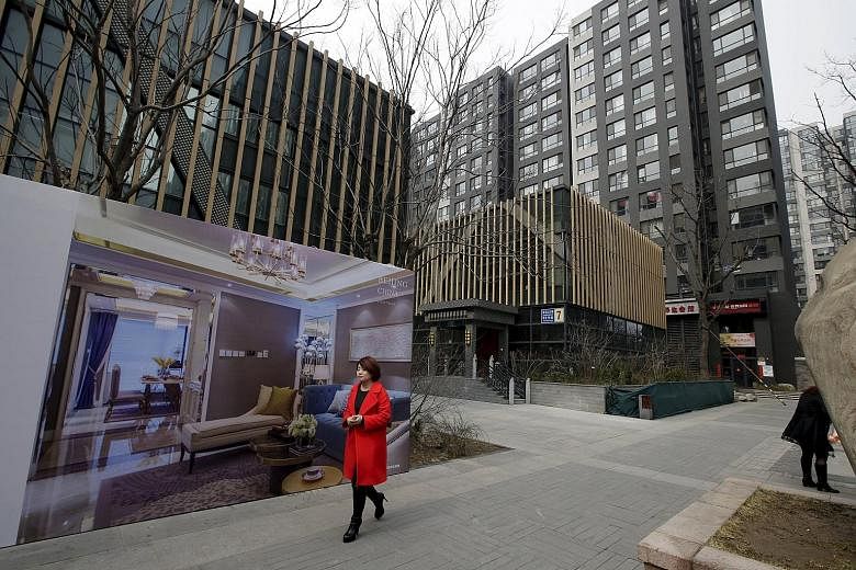A property advertisement outside luxury apartment blocks in central Beijing. A new survey showed average prices in China's 100 biggest cities rose 7.4 per cent last month over the same period last year, the eighth year-on-year rise in a row.