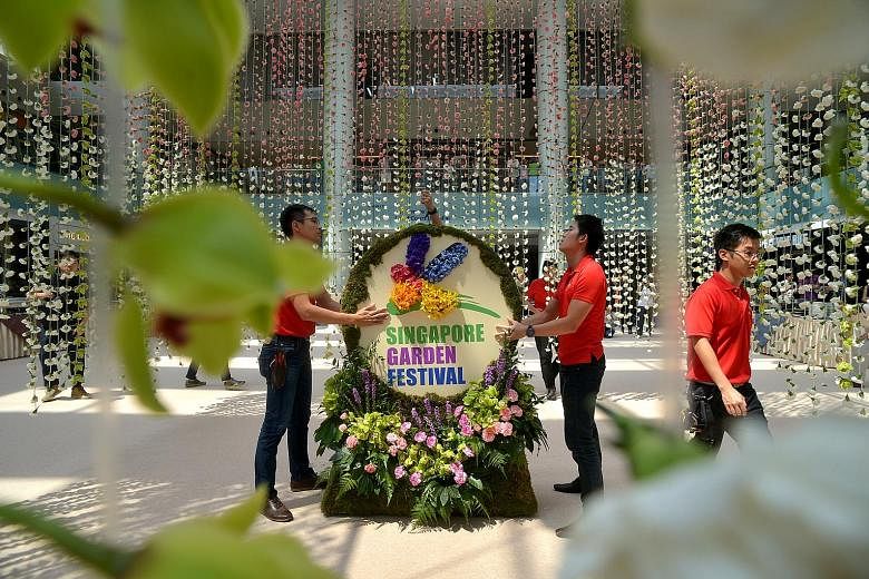 Workers putting the finishing touches to the the world's largest floral chandelier, made from more than 60,000 flowers, which set a Guinness World Record.