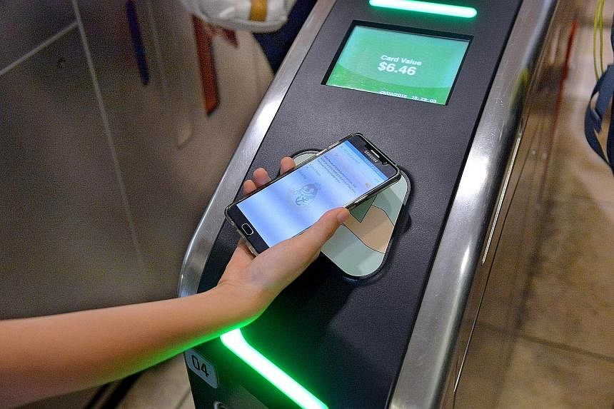 Commuters can now tap their compatible smartphones at card readers to pay for bus and train rides.