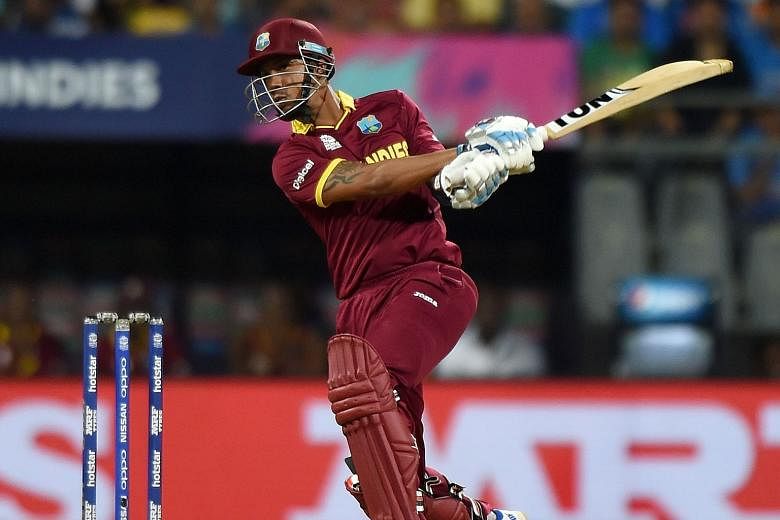West Indies batsman Lendl Simmons playing a shot during the semi-final against India. His unbeaten 82 was matched by Virat Kohli's 89 not out at Mumbai's Wankhede Stadium but it was the Caribbean side who nicked the match with two balls to spare. 