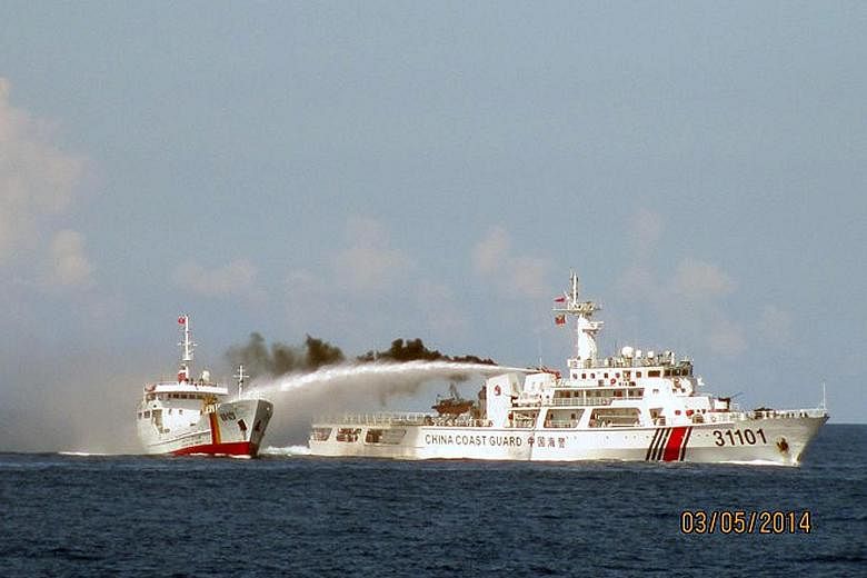 A Chinese vessel (right) using a water cannon on a Vietnamese vessel near the Paracel islands in May 2014. Chinese boats reportedly rammed Vietnamese vessels near disputed waters where China had stationed an oil drilling platform. Fish produce at a m