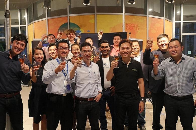 (Front row, from left) Mr Lim, head of SPH Plug and Play; Mr Julian Tan, head of SPH Digital Division; Mr Chua Boon Ping, CEO of SPH Media Fund; Dr Alex Lin, head of Infocomm Investments; and Mr Jupe Tan, senior vice-president of global operations fo