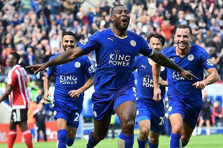 Leicester captain Wes Morgan (front) celebrating his goal. He claimed he had been ill on Saturday but was determined to play yesterday's game.