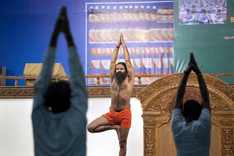 Mr Ramdev teaching yoga in Haridwar, India, on Feb 26. He is is the leader of what brand specialists call the Baba Cool Movement, where spiritual men market health products based on ayurveda.