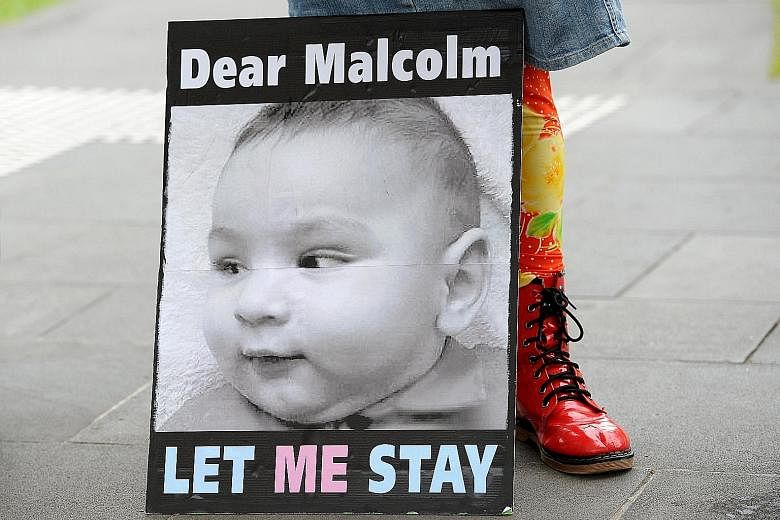 A poster at a demonstration in Melbourne on Feb 19 calling for PM Turnbull to allow infant children of asylum-seekers to stay in Australia, and not in offshore centres.
