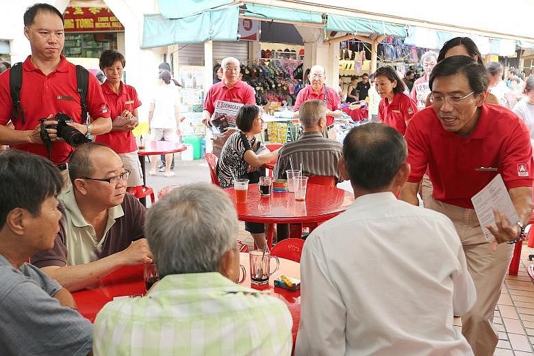SDP's Dr Chee meeting residents at a coffee shop in the constituency yesterday. Among the party supporters who accompanied him on the walkabout was his sister, Siok Chin (left, behind the photographer). PAP's Mr Murali and Ms Low chatting with reside
