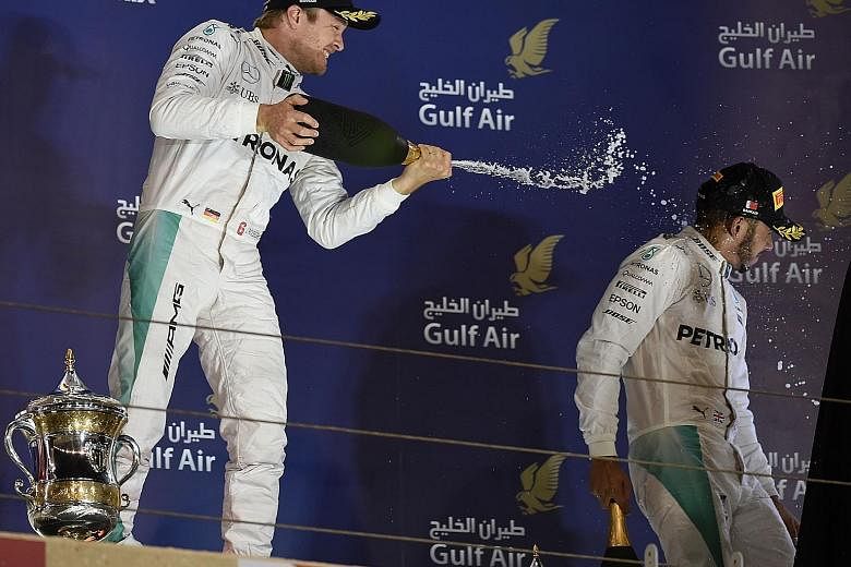 A triumphant Nico Rosberg spraying champagne on team-mate Lewis Hamilton, who finished third behind Ferrari's Kimi Raikkonen in Sunday's Bahrain Grand Prix. Despite a five-race drought, the Briton is confident he can sort out his start problems soon 
