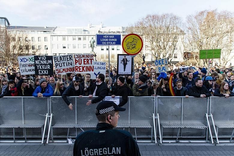 Protesters calling for the resignation of Icelandic Prime Minister Sigmundur David Gunnlaugsson (far right), at Austurvollur Square in Reykjavík on Monday. The Panama Papers had named his wife in connection with a secretive firm in an offshore haven