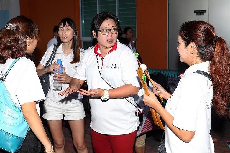 Keeping Hope Alive's founder, Ms Phua (centre), and her fellow volunteers visit estates around the island, spending a few weeks at each. If flats need cleaning, they roll up their sleeves and get started. If light bulbs need to be changed, they do it