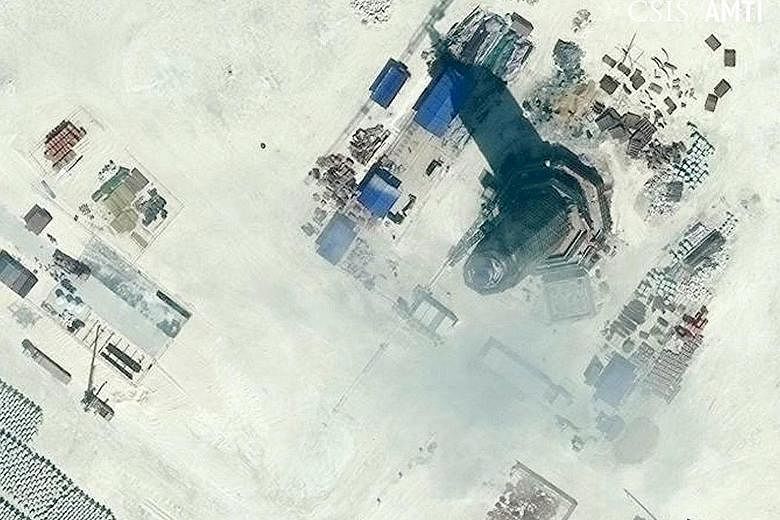 Satellite images showing the 55m-high lighthouse (above) on Subi Reef (left), near where the US guided-missile destroyer USS Lassen sailed last October. The official Xinhua news agency said the lighthouse "can provide efficient navigation services su