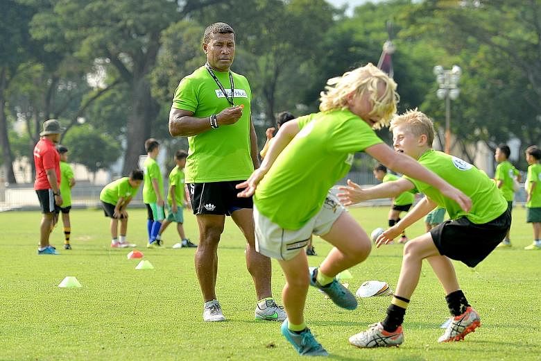 Fiji rugby sevens legend Waisale Serevi, 47, putting some of his 70 workshop participants through their paces at the Padang yesterday.