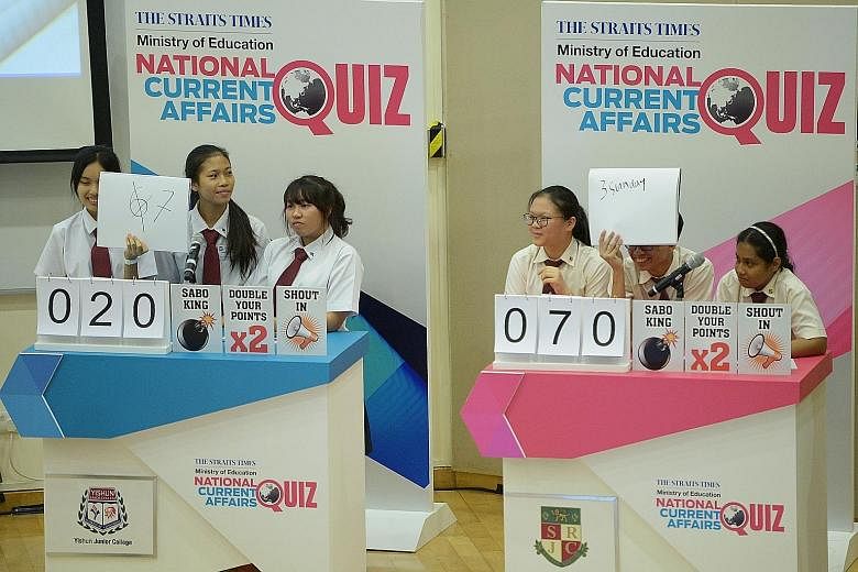 The trio from Yishun Junior College (left) competing against the Serangoon Junior College team yesterday. YJC scored the highest in the first round of The Straits Times-Ministry of Education National Current Affairs Quiz. The team went home with vouc