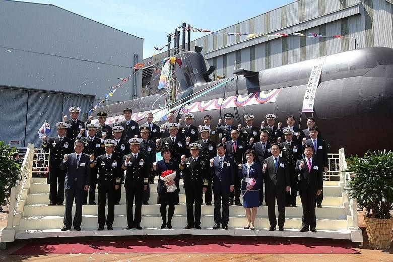 Guests including South Korea's chief of naval operations posing in front of the new submarine Hong Beom Do at its launch ceremony on Tuesday at the Hyundai Heavy Industries dockyard in the south-eastern city of Ulsan. The 1,800-tonne, diesel-electric
