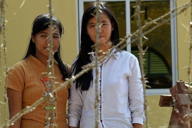 Detained Myanmar students (from left) Honey Oo, 28, and Phyo Phyo Aung, 27, outside the Tharrawady court house before their trial. They are among some 40 students facing charges including unlawful assembly.
