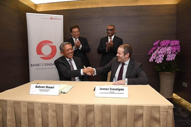 Mr Shaari (seated, left), Bank of Singapore CEO, with Barclays strategy and corporate development director James Trevelyan at a signing ceremony in OCBC Centre yesterday. With them are OCBC Bank's group CEO Samuel Tsien and Barclays Wealth, Entrepren