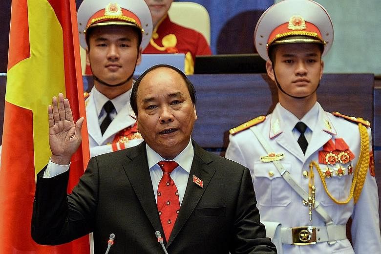 Prime Minister Nguyen Xuan Phuc being sworn in at Parliament House in Hanoi yesterday.