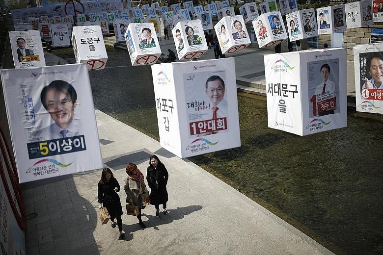 Posters of candidates for the parliamentary elections in central Seoul. Expected low turnout at the polls next Wednesday is likely to work to the advantage of President Park's ruling Saenuri Party.