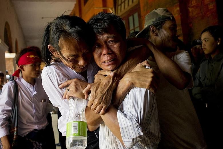 A released student protester and family members during an emotional reunion outside the courthouse in Tharrawaddy yesterday.