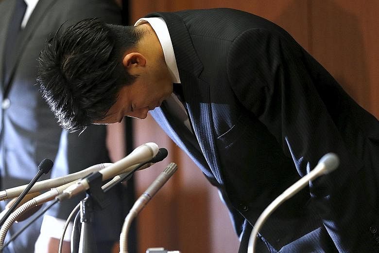 Japanese badminton player Kento Momota bowing deeply at a news conference yesterday after he apologised for betraying his nation's hopes by gambling at an illegal casino in Tokyo.