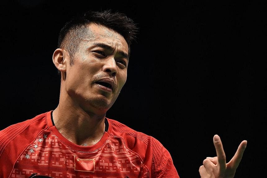 China's Lin Dan (above) reacting after losing a point against Denmark's Jan Jorgensen during their Malaysia Open quarter-final at the Malawati stadium yesterday. Carolina Marin (left) in action against Wang Yihan of China during their quarter-final, 