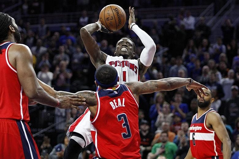 Detroit Pistons guard Reggie Jackson taking a shot against Washington Wizards' Bradley Beal during the fourth quarter on Friday. Jackson's big game helped the Pistons clinch a play-off berth.