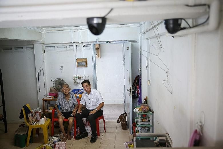 Retired cleaner Wee Yok Tai (left), who lives alone, is afraid of dying alone without anyone knowing. To help him, undertaker Roland Tay (right) has installed two CCTV cameras in Mr Wee's home, and monitors the live footage at least three times a day