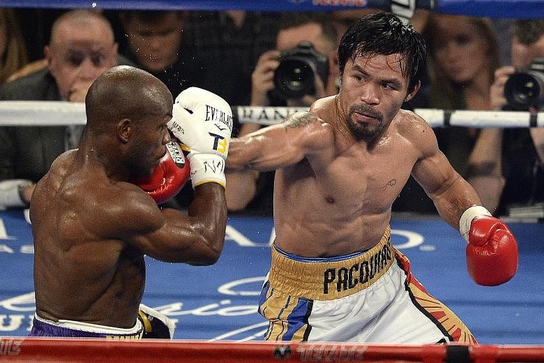 Manny Pacquiao landing a punch against Timothy Bradley in the fifth round, in which he unleashed a series of combinations to score heavily. The Filipino looked fresh and in great form despite an 11-month break, knocking down the American twice on his