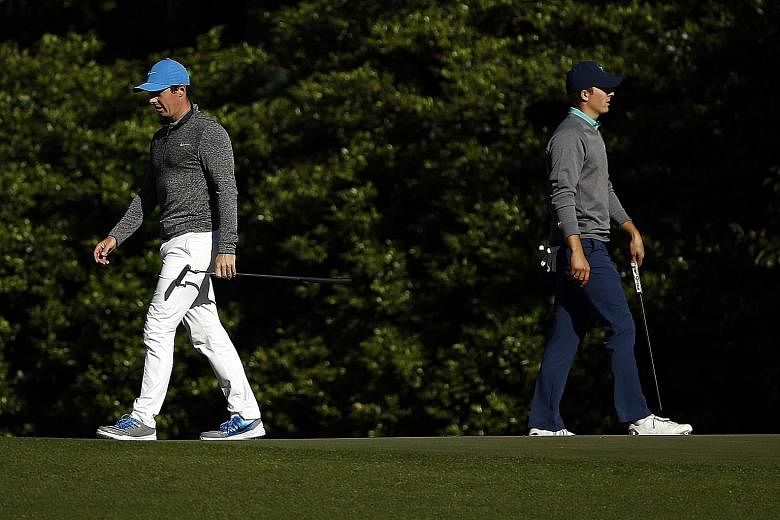 Northern Irishman Rory McIlroy (left) and American Jordan Spieth walk the 11th green during the third round of the Masters at Augusta National Golf Club.