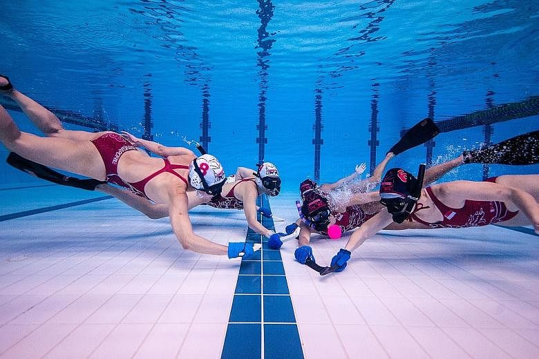 The national women's team tussling for the puck in training. They finished a respectable 11th out of 13 teams at the Underwater Hockey World Championships last month.