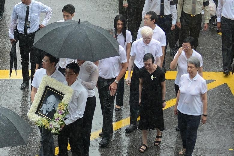 Dr Lee Wei Ling (wearing black), the younger sister of Prime Minister Lee Hsien Loong, walking alongside family members at Mr Lee Kuan Yew's funeral in March last year.