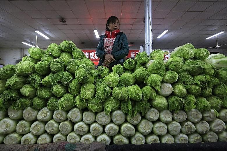 Vegetables being sold at a market in Beijing. China's consumer prices remain strong in March, driven mainly by rising vegetable and pork prices.