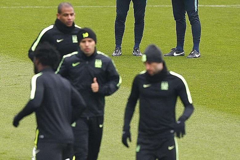 Manchester City manager Manuel Pellegrini (far right) and his assistant Ruben Cousillas watching over training as they prepare to face Paris Saint-Germain in their Champions League quarter-final, second-leg clash.