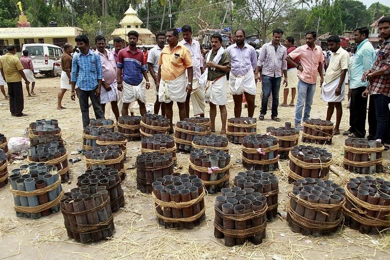 Empty firecracker shells inside the Puttingal Temple compound in the Kollam district of Kerala on Sunday. Witnesses described mass panic after Sunday's explosion, which left more than 100 people dead. The blast is thought to have been sparked by a fi