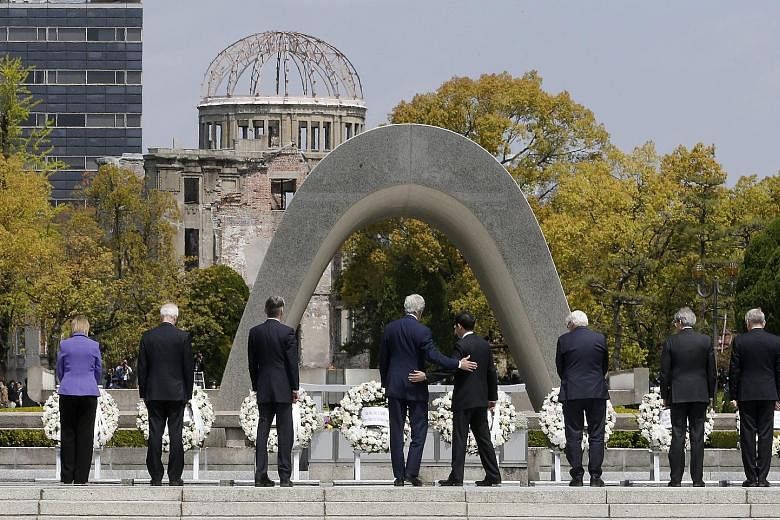 Mr Kerry (fourth from left) with his Japanese counterpart Fumio Kishida (fifth from left) and other G-7 foreign ministers at a wreath-laying ceremony for Hiroshima atomic bombing victims at the memorial park.