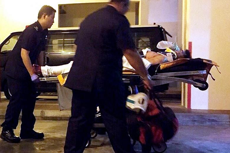 Zheng Xianghua (left, being wheeled away to hospital after the tragedy) stabbed himself in the chest and slashed his neck after killing Madam Wang Xueyan (above) in his rented room in Tampines in December 2014.