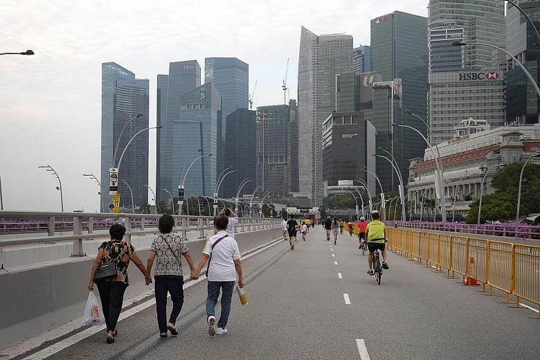 Strollers and cyclists taking advantage of car-free Sunday in the CBD last month. Transport Minister Khaw Boon Wan yesterday said that learning to drive and owning a car might be a thing of the past, and Singapore needed to prepare for such a future 