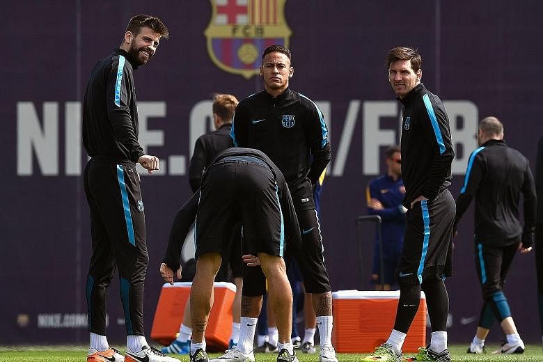 From left: Defender Gerard Pique with forwards Neymar and Lionel Messi during training on the eve of their Champions League quarter-final second leg at Atletico Madrid. Leaders Barcelona have lost their last two La Liga matches and drawn the third.