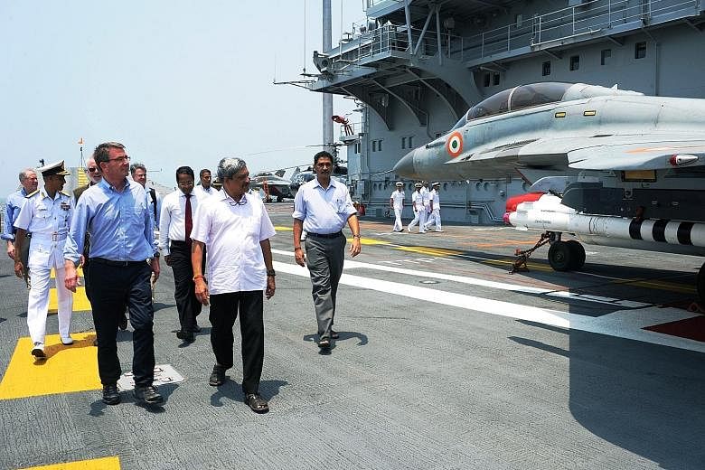 US Defence Secretary Ashton Carter (left) and Indian Defence Minister Manohar Parrikar (in short sleeves) touring the Indian Navy's flagship, INS Vikramaditya, in Mumbai. The US is seeking closer defence cooperation with India as concerns in the regi
