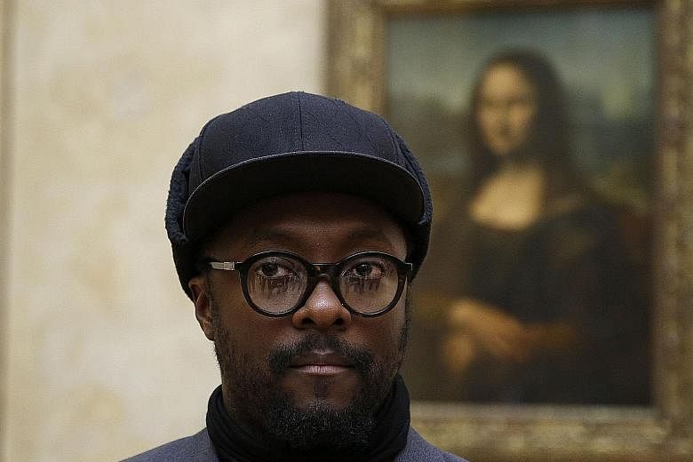 Black Eyed Peas frontman will.i.am (above) in front of the Mona Lisa painting by Italian artist Leonardo da Vinci at the Louvre museum on Tuesday.