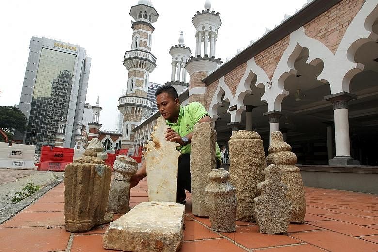 The gravestones unearthed near Jamek Mosque (left) are made of granite, marble and sandstone (right). Workers have now been alerted to look out for more artefacts