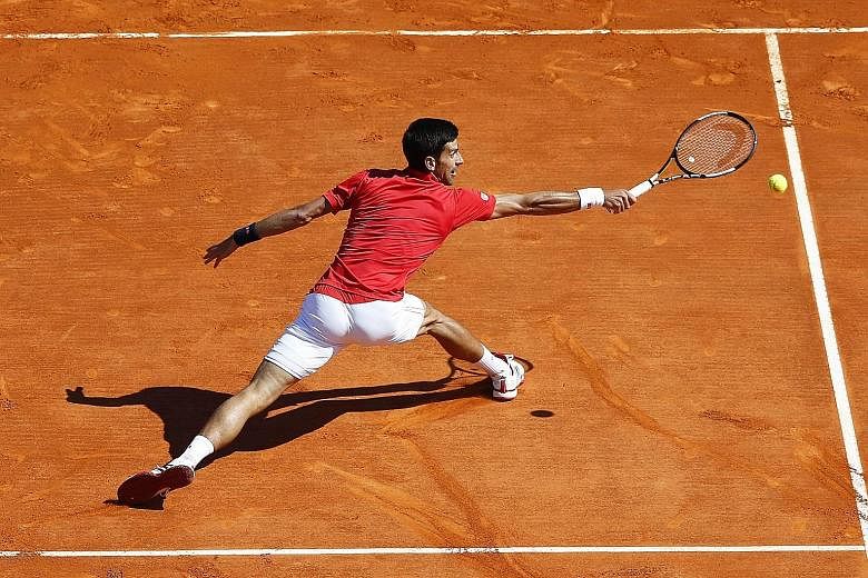 Novak Djokovic stretches to return to Jiri Vesely during their Monte Carlo Masters second-round match. This is only the second time this year that the Serb has not left a tennis court with a victory, after retiring due to illness in Dubai in February