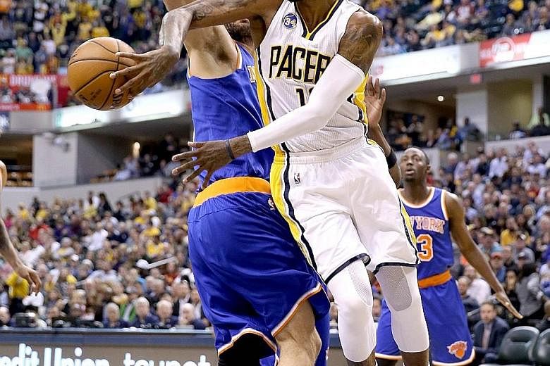 Paul George of the Indiana Pacers passes the ball during his team's 102-90 win over the New York Knicks at the Bankers Life Fieldhouse in Indianapolis. The Pacers will face the Toronto Raptors in the first round of the Eastern Conference play-offs.